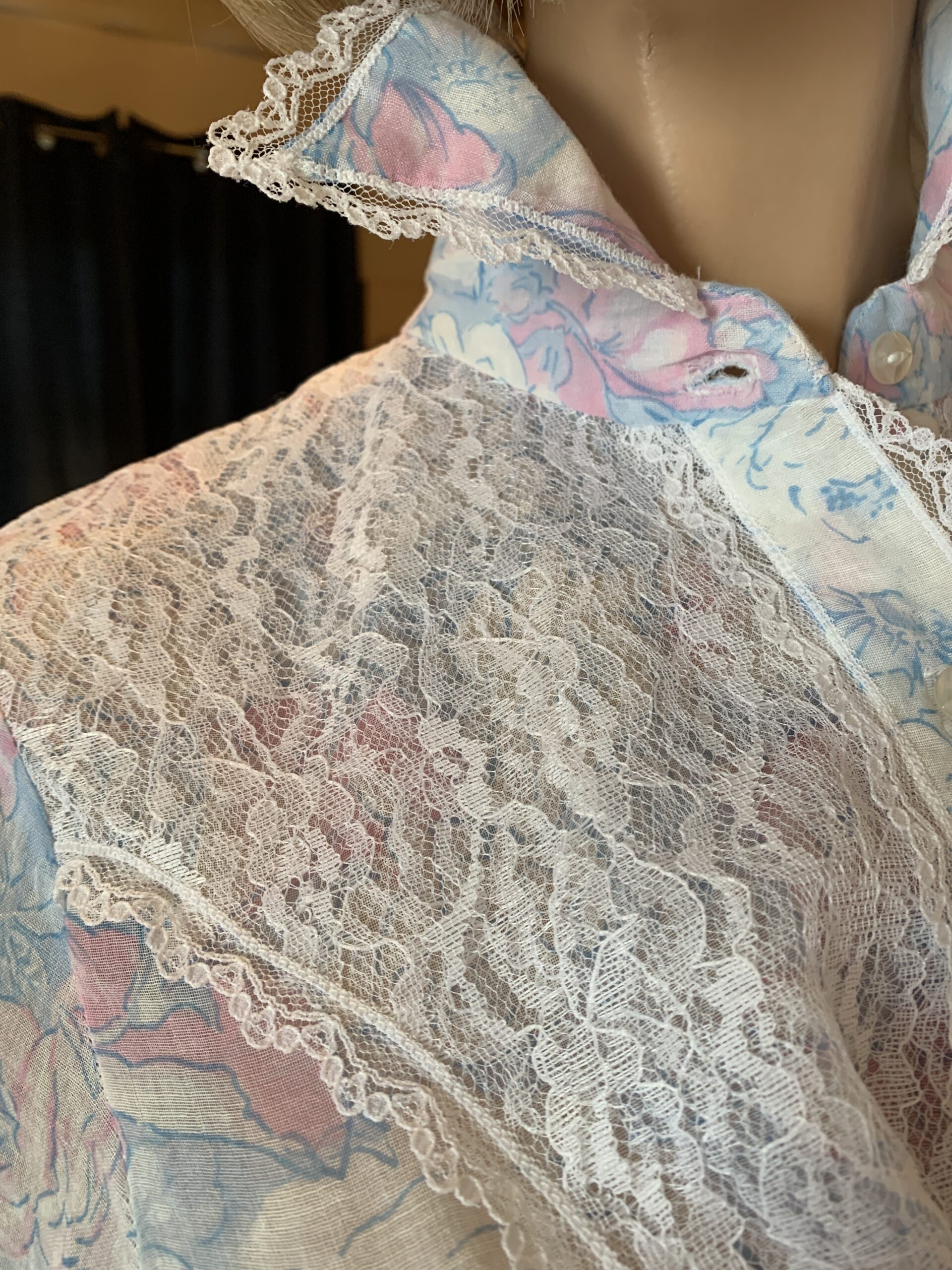 Vintage handmade prairie dress in sheer floral voile with high neckline, lace detailing, and button-front styling.