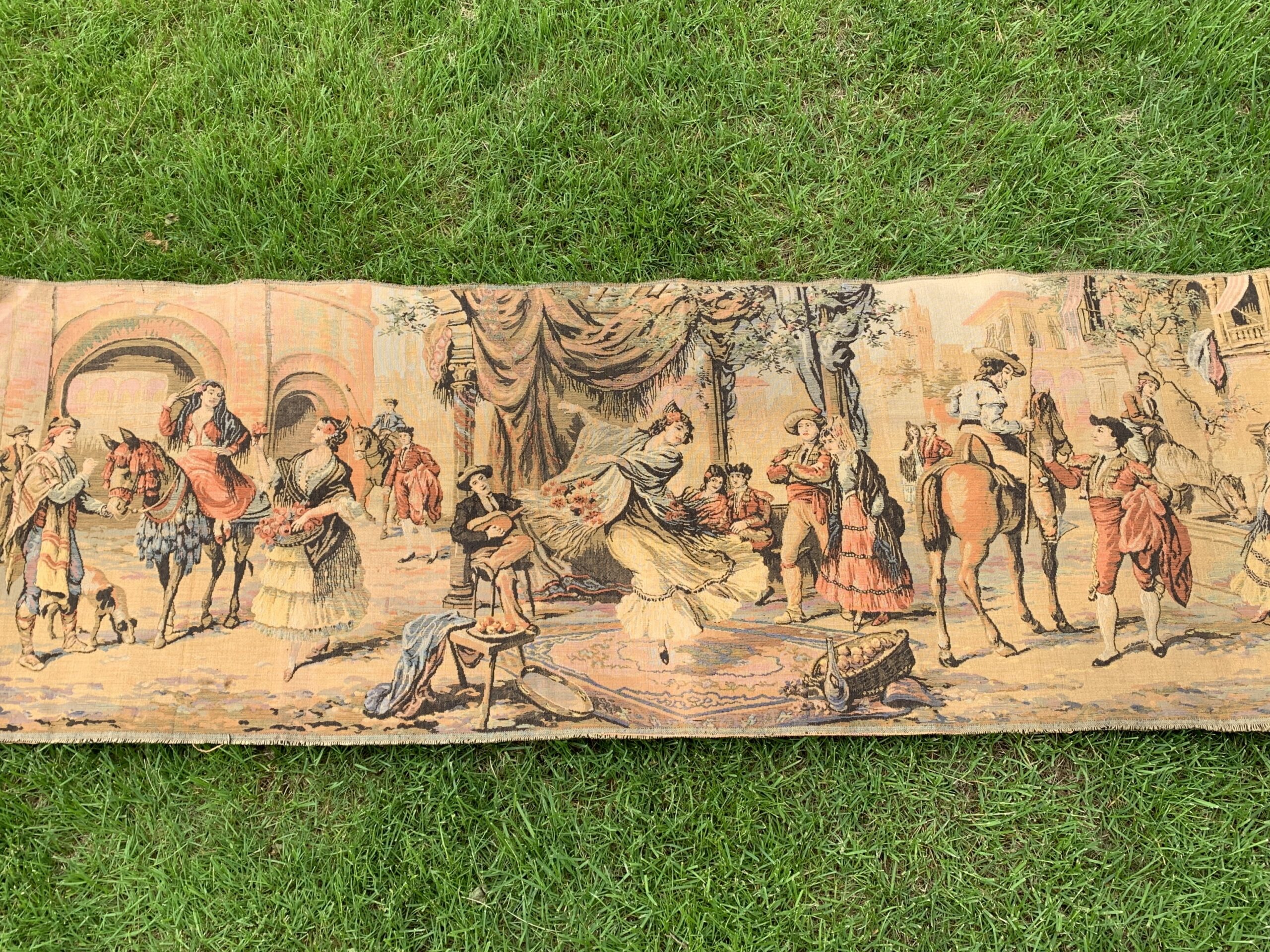 Vintage woven tapestry depicting a Spanish courtyard scene with dancer, musicians, riders, and figures in a romantic architectural setting.