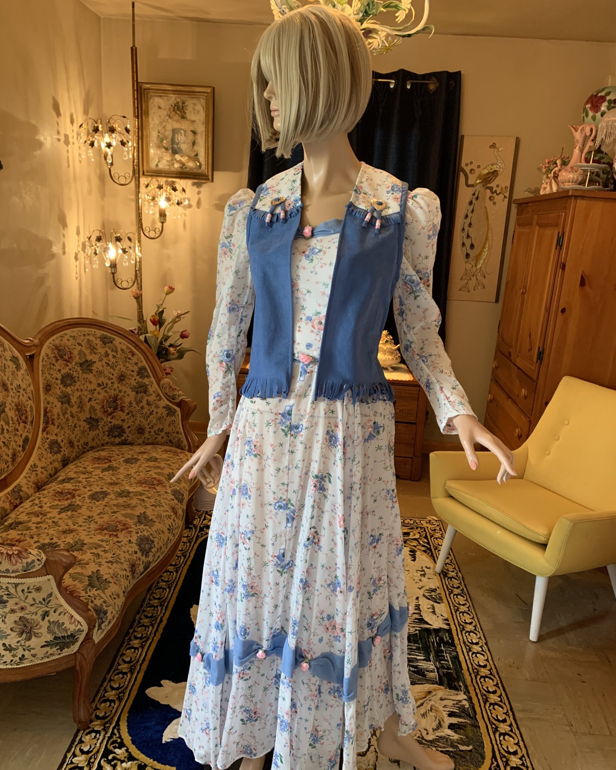 Handmade western prairie dress styled with removable blue vest featuring fringe trim, beadwork, and heart-shaped conchos.