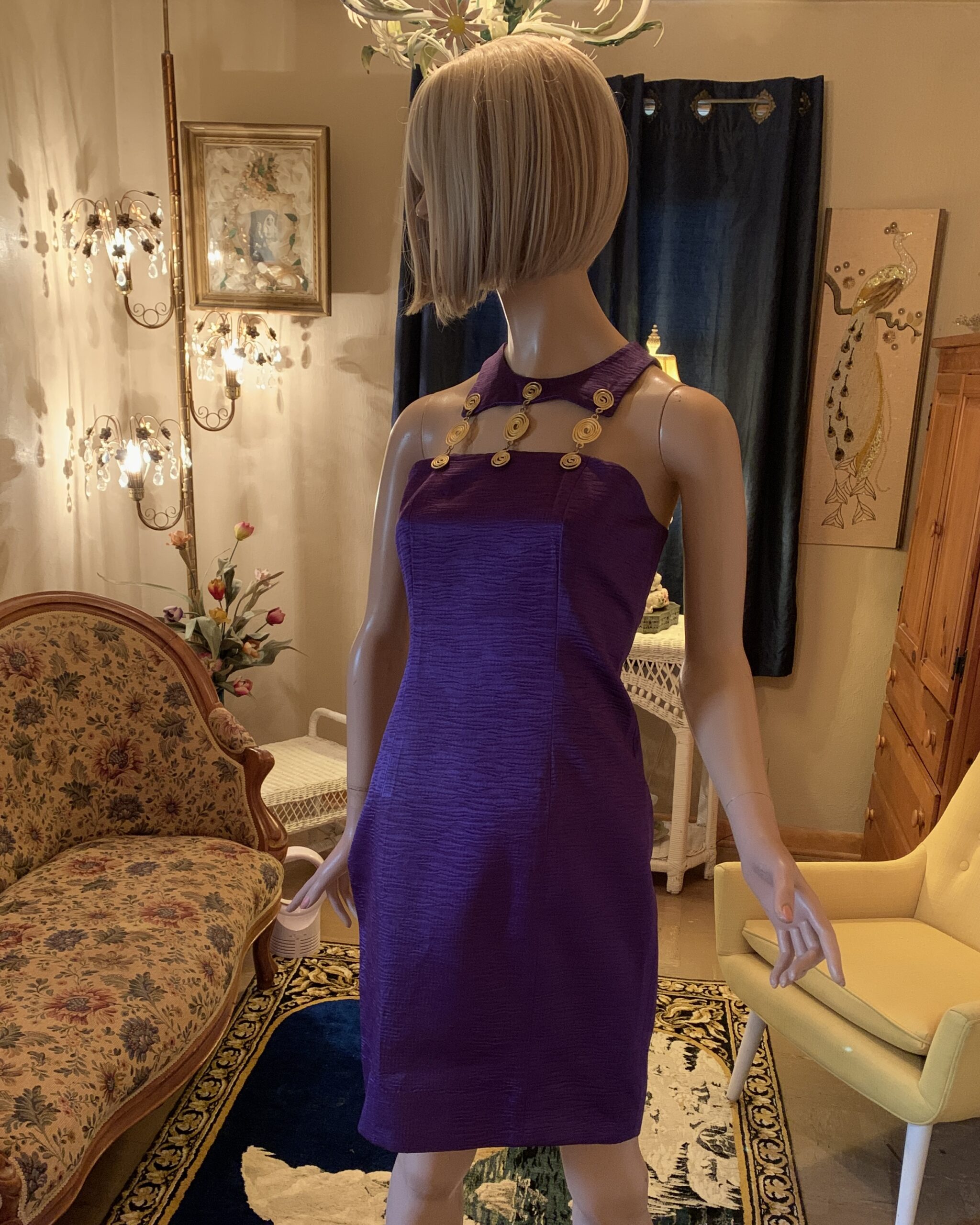 Front view of a 1980s Linda Separates violet sheath dress with a sculptural gold spiral neckline, textured fabric, sleeveless cut, and classic fitted silhouette.