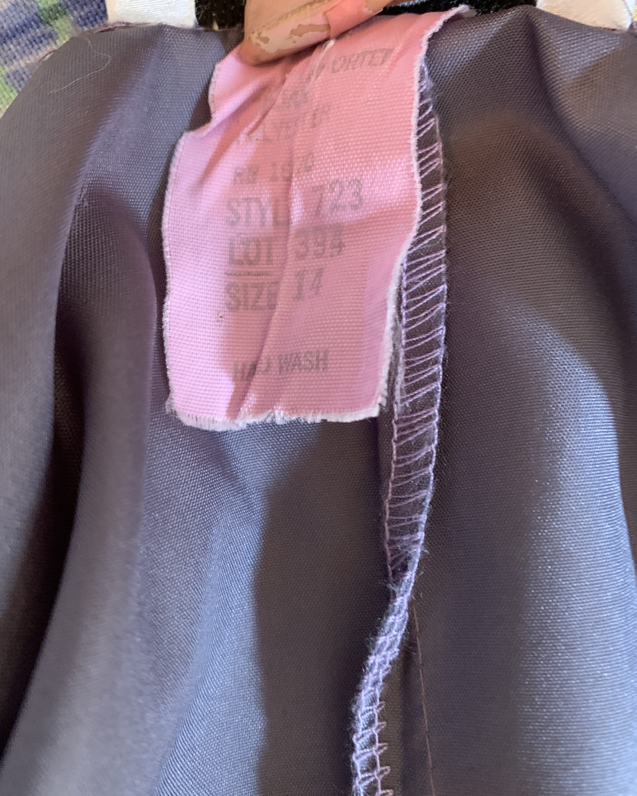 Interior care label showing size 14, 100% polyester fabric, and machine washable care instructions.