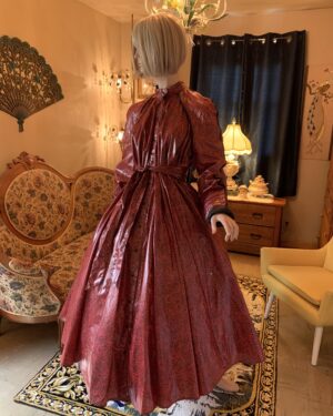 Vintage Barboglio Cristina-Jan floral coat dress in rich red and black with sculptural sleeves, quilted cuffs, tie belt, and glossy raincoat-like finish.
