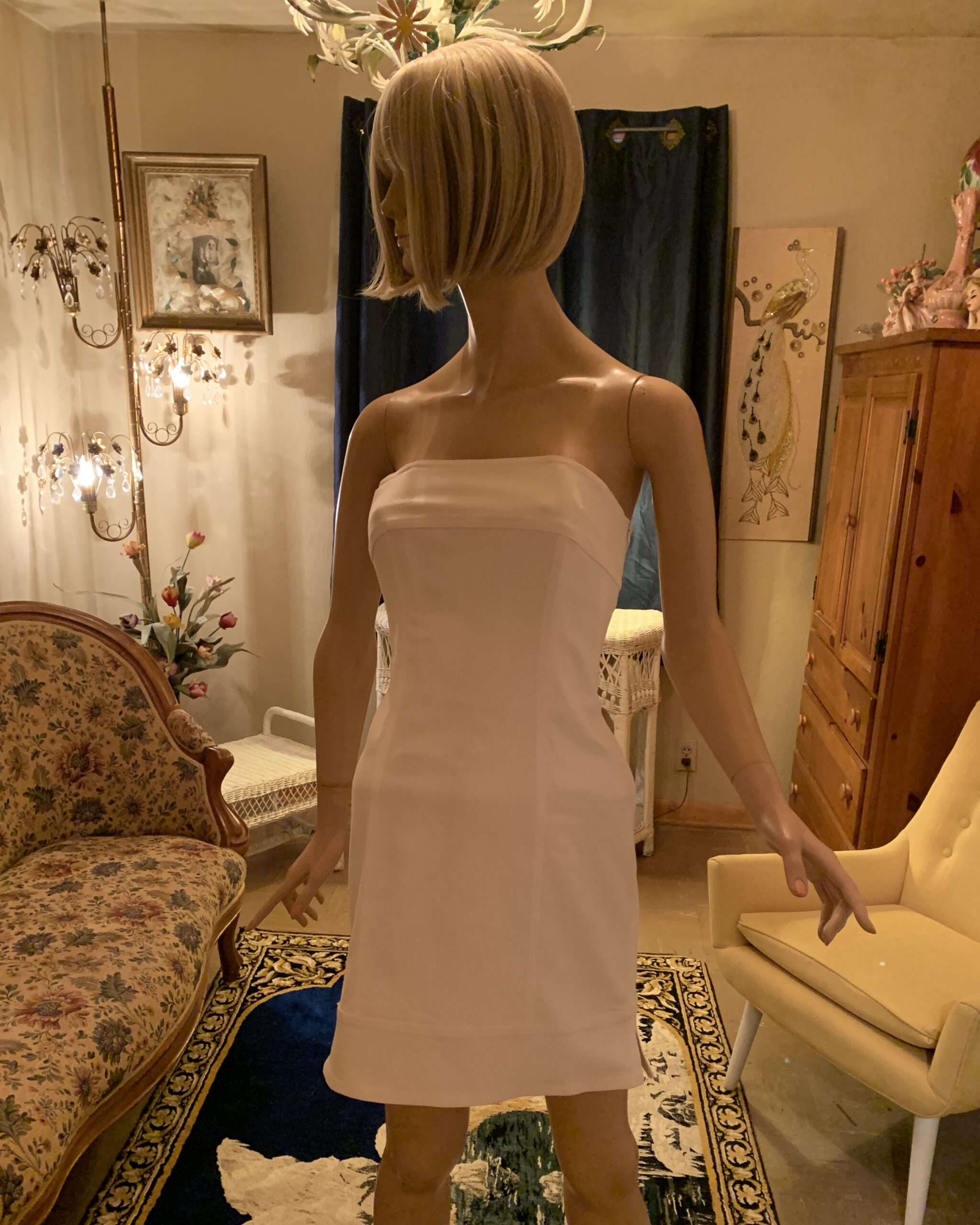 Linda Segal Separates white strapless mini dress with fitted silhouette displayed on mannequin.