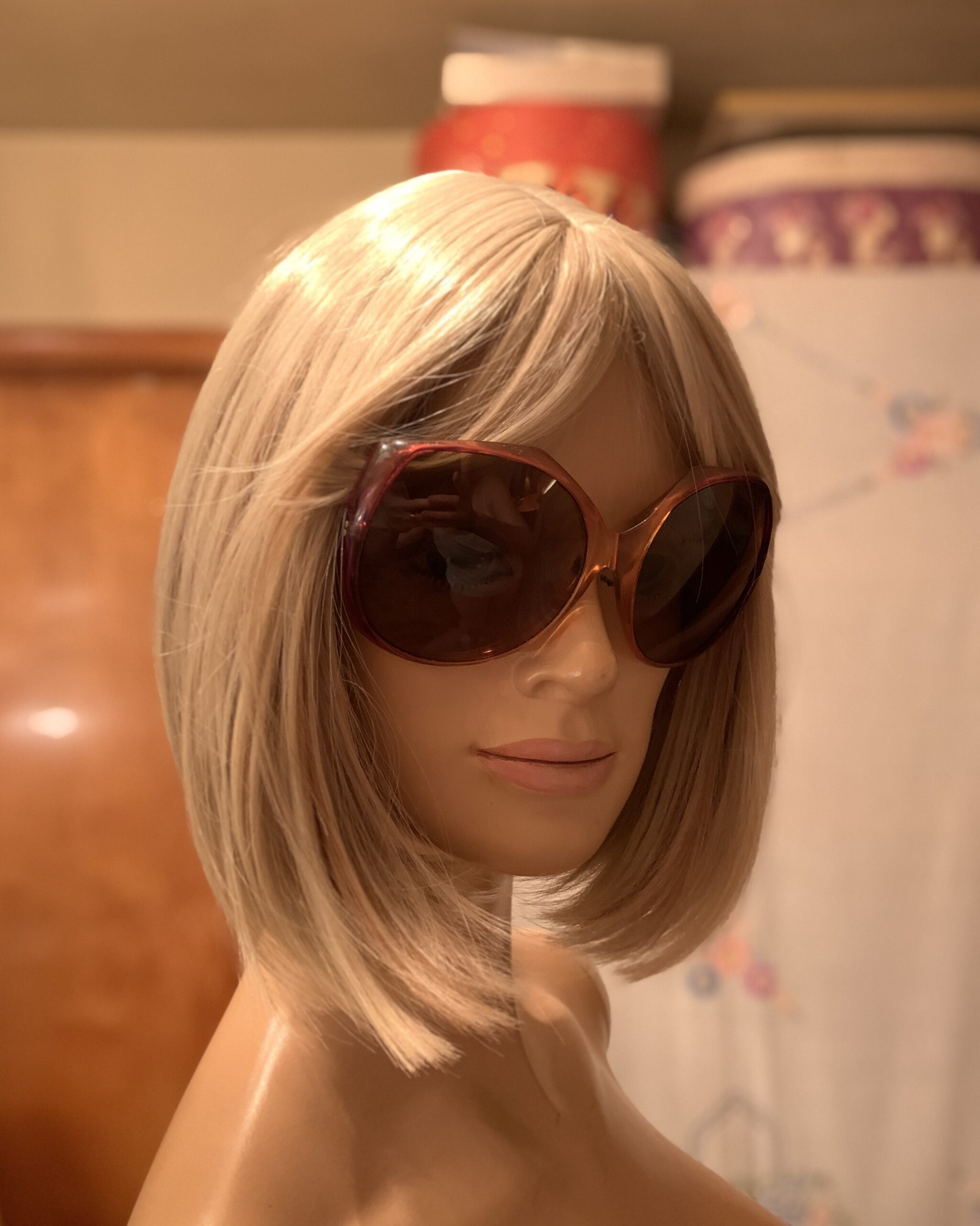 Side view of vintage 1970s oversized amber ombré sunglasses on a blonde mannequin showcasing the oversized silhouette.