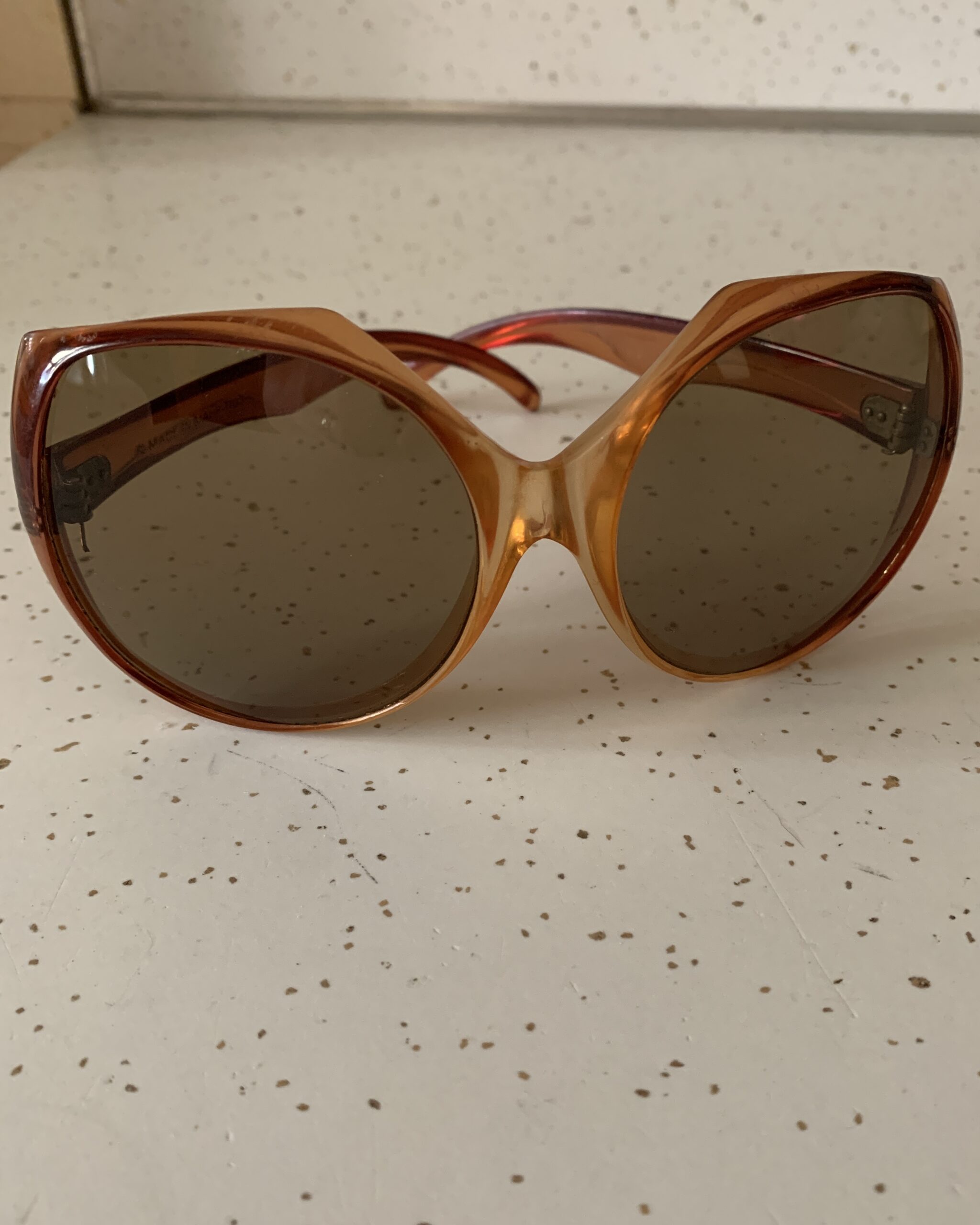 Vintage 1970s oversized amber ombré sunglasses with brown tinted lenses and translucent acetate frame.