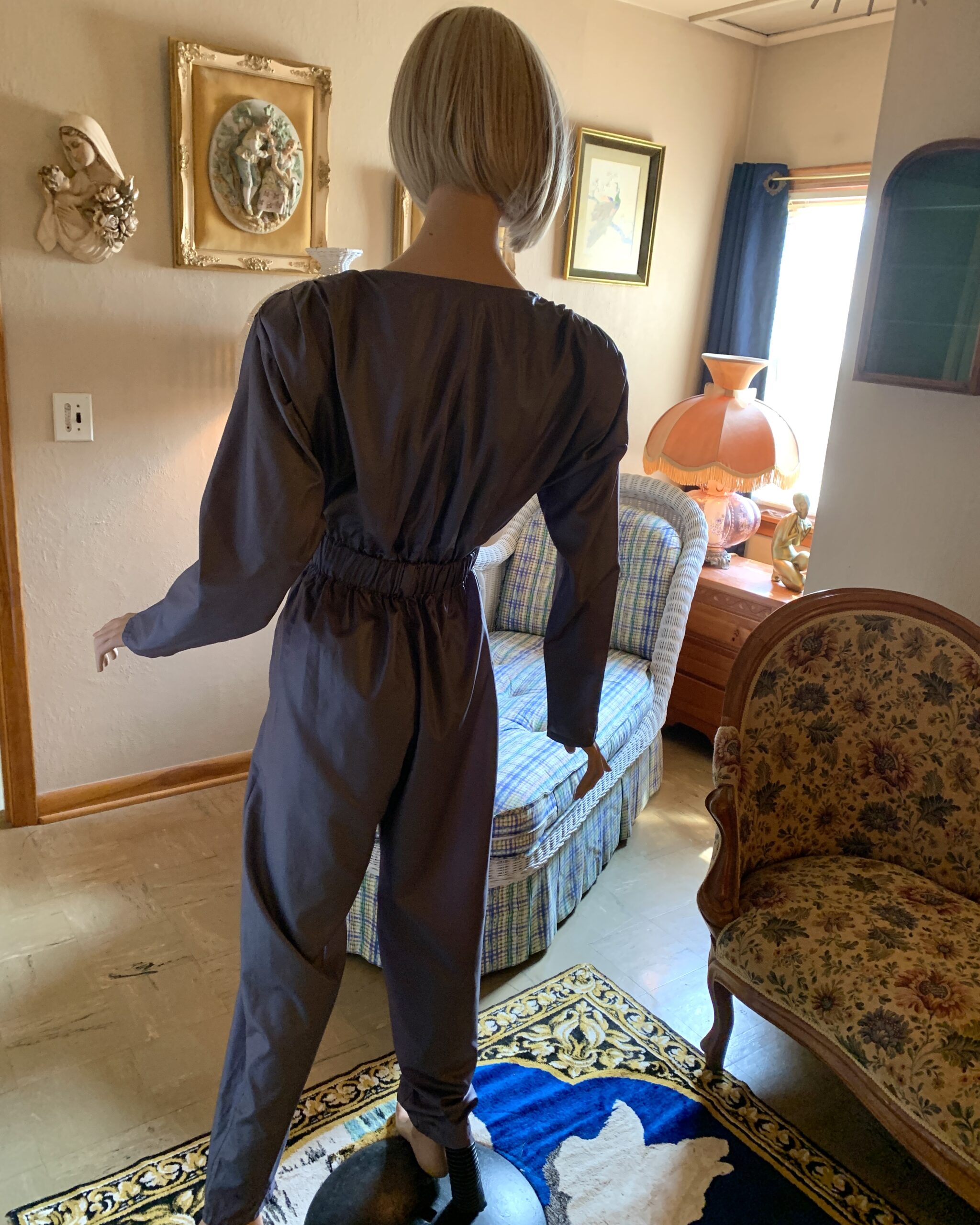 Back view of vintage Antonio Ruspoli jumpsuit showing elasticized waist, long sleeves, and tapered leg silhouette.
