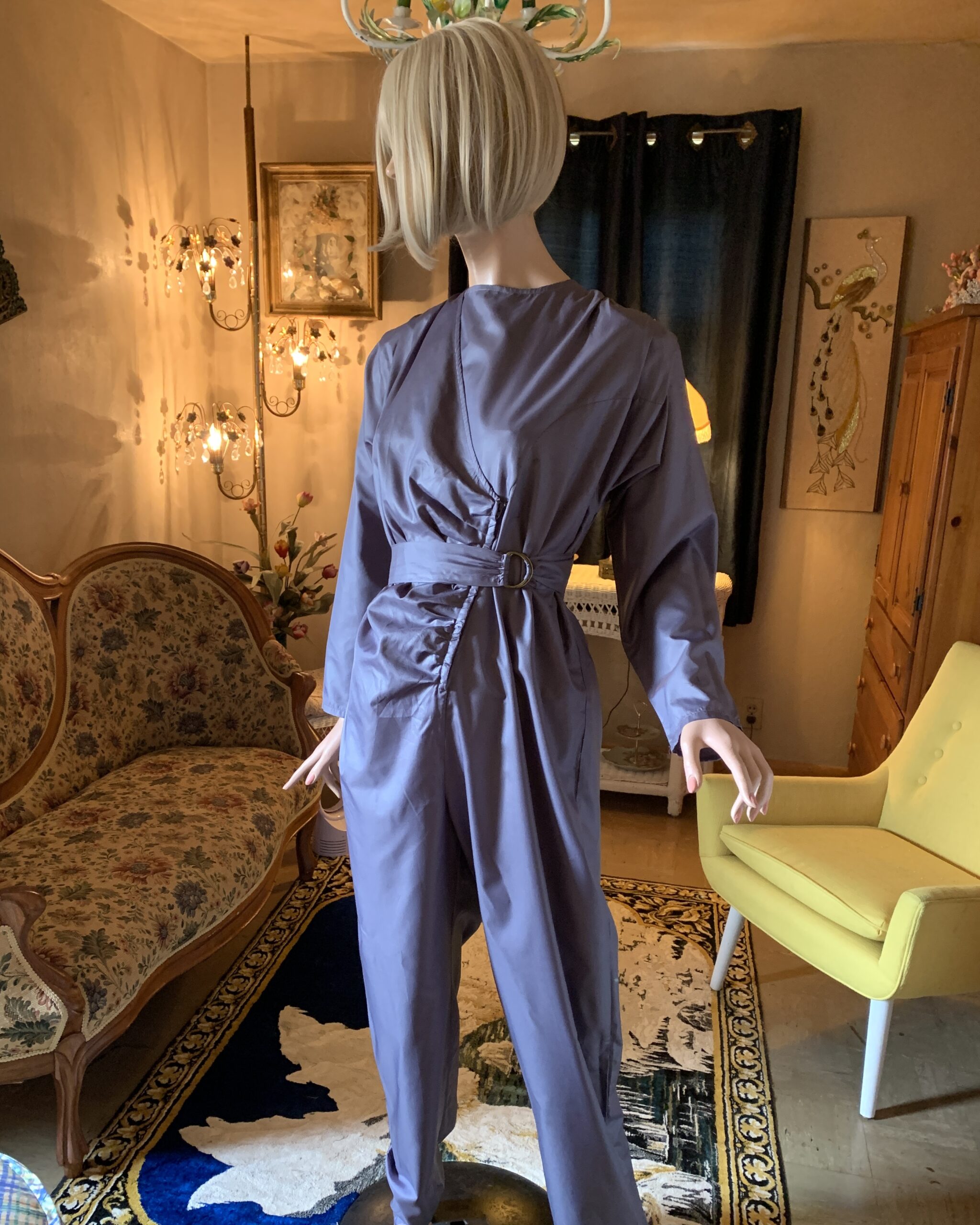 Three-quarter front view of vintage Antonio Ruspoli designer jumpsuit in slate lavender with ruched bodice and flattering belted waist.