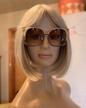 Vintage Christian Dior oversized cream and burgundy sunglasses with brown gradient lenses displayed on a blonde mannequin.