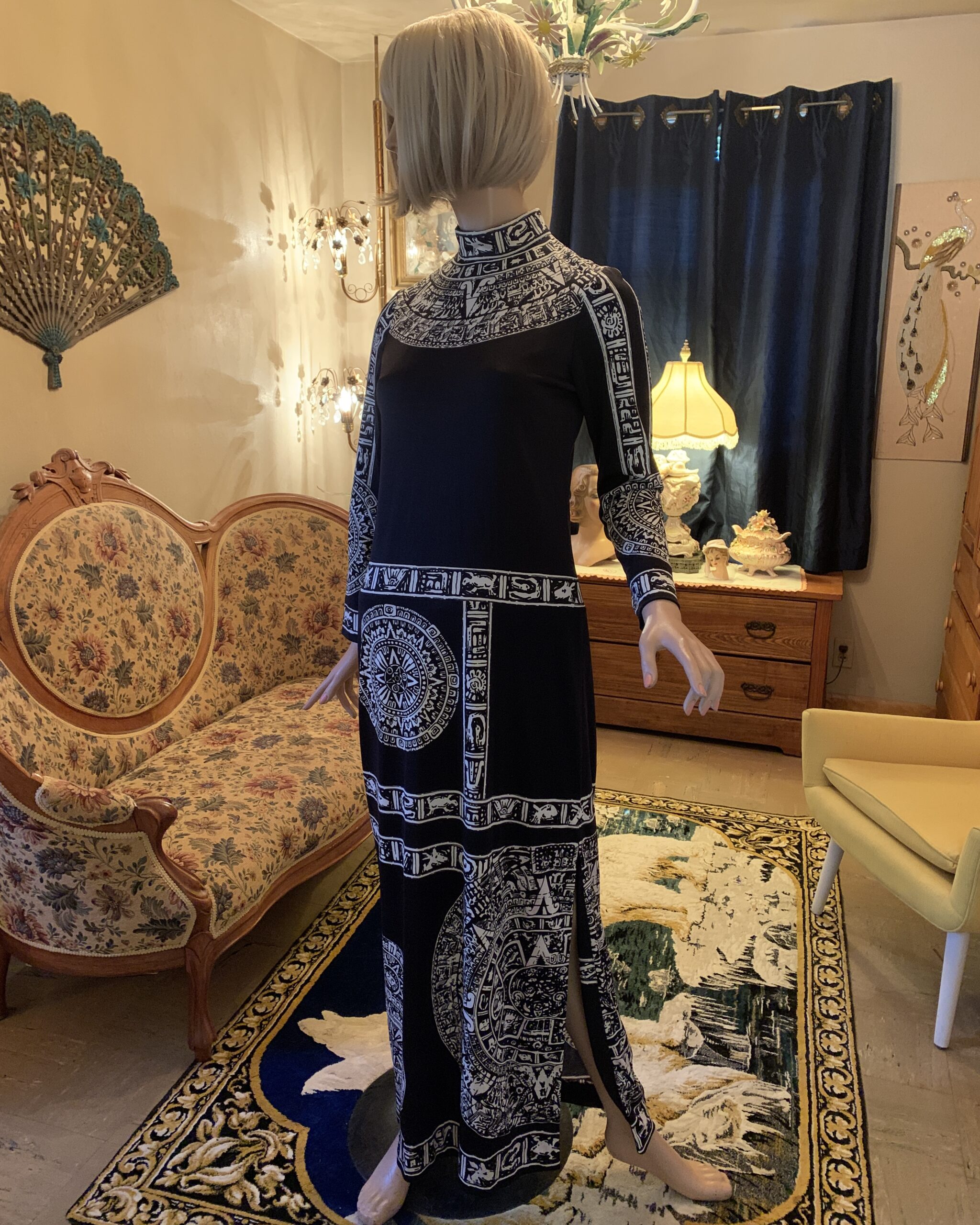 Three-quarter view of vintage Paganne by Gene Berk maxi dress with high neckline, long sleeves and bold black and ivory print.