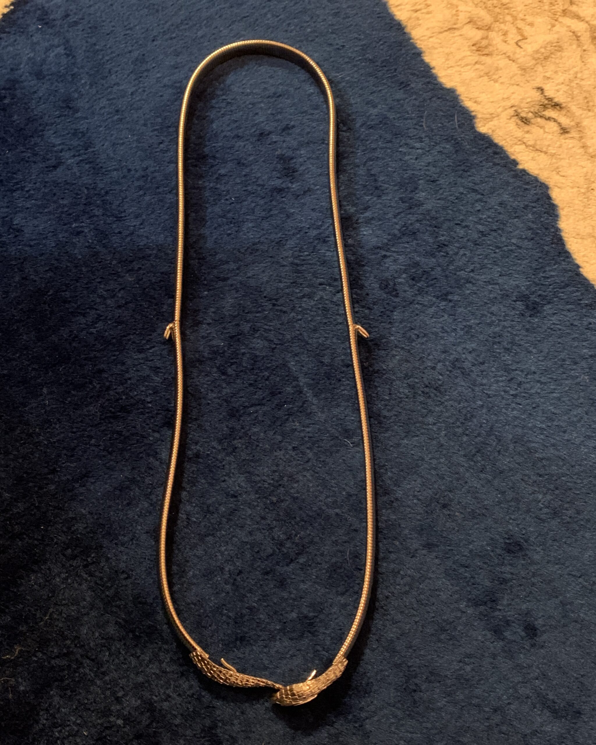 Vintage Accessocraft N.Y.C. snake belt shown laid flat with flexible silver-tone coil construction.