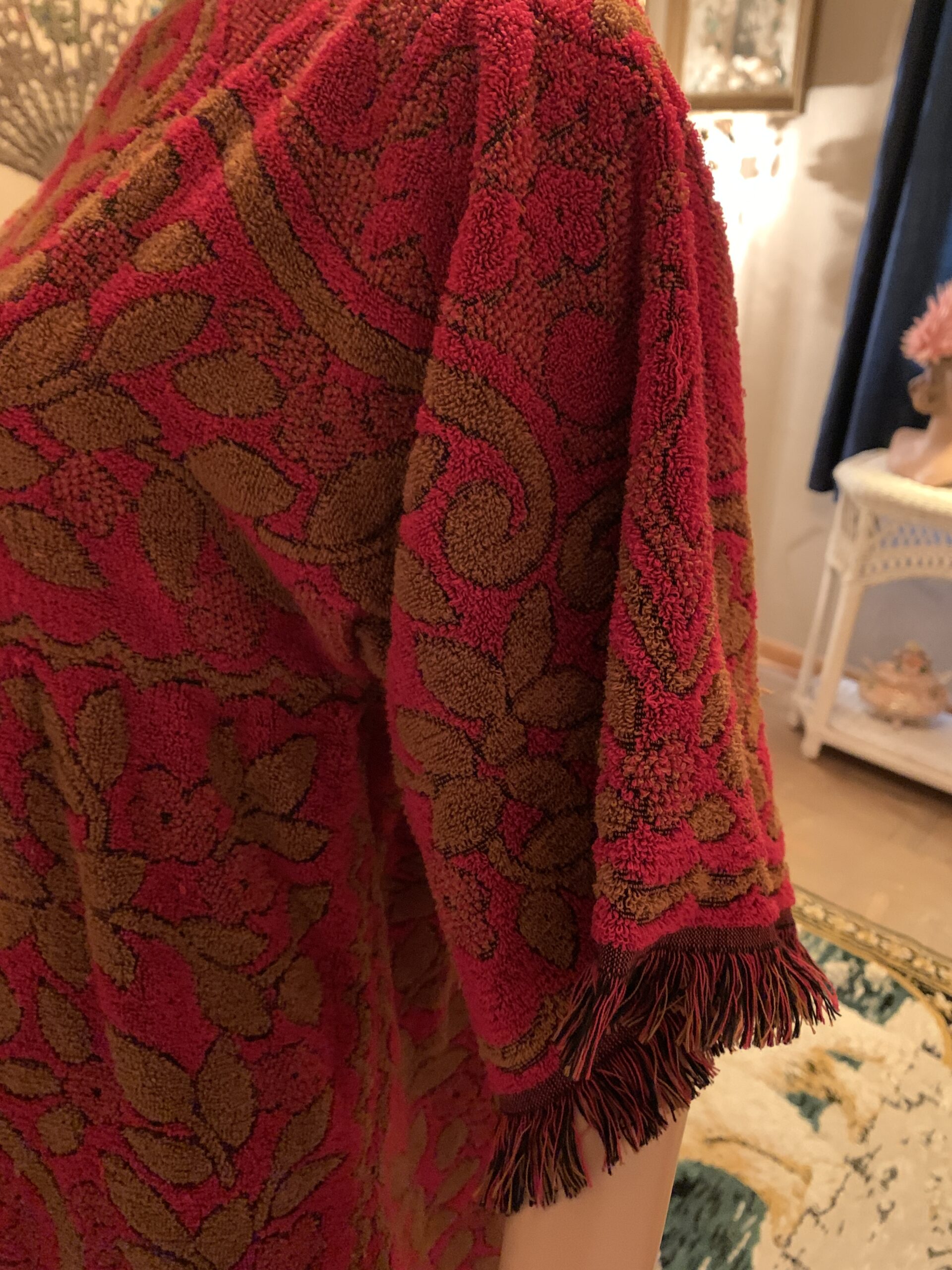 Close-up of Cannon Cavalier terry towel dress showing heavyweight cotton texture and brown fringe sleeve trim.
