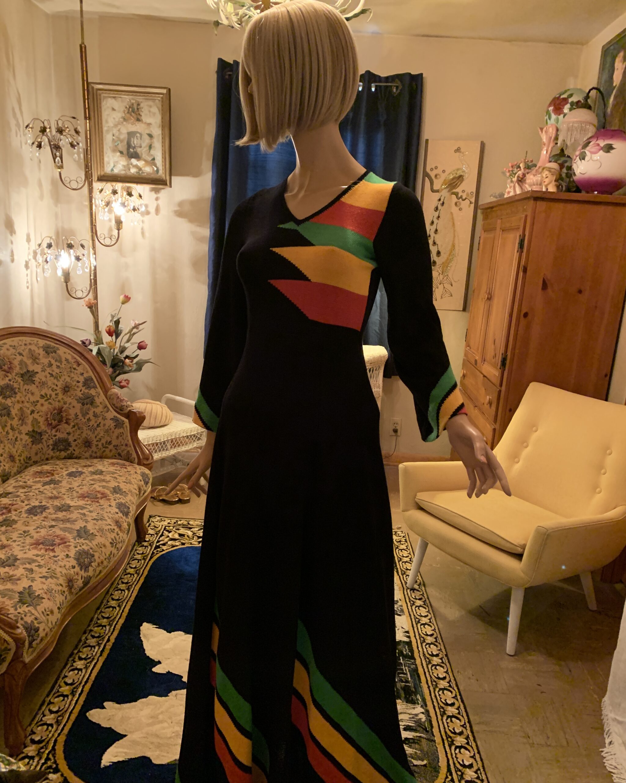Front view of late 1960s to early 1970s black mercerized cotton maxi dress with bold green, red and golden yellow colorblock knit design.