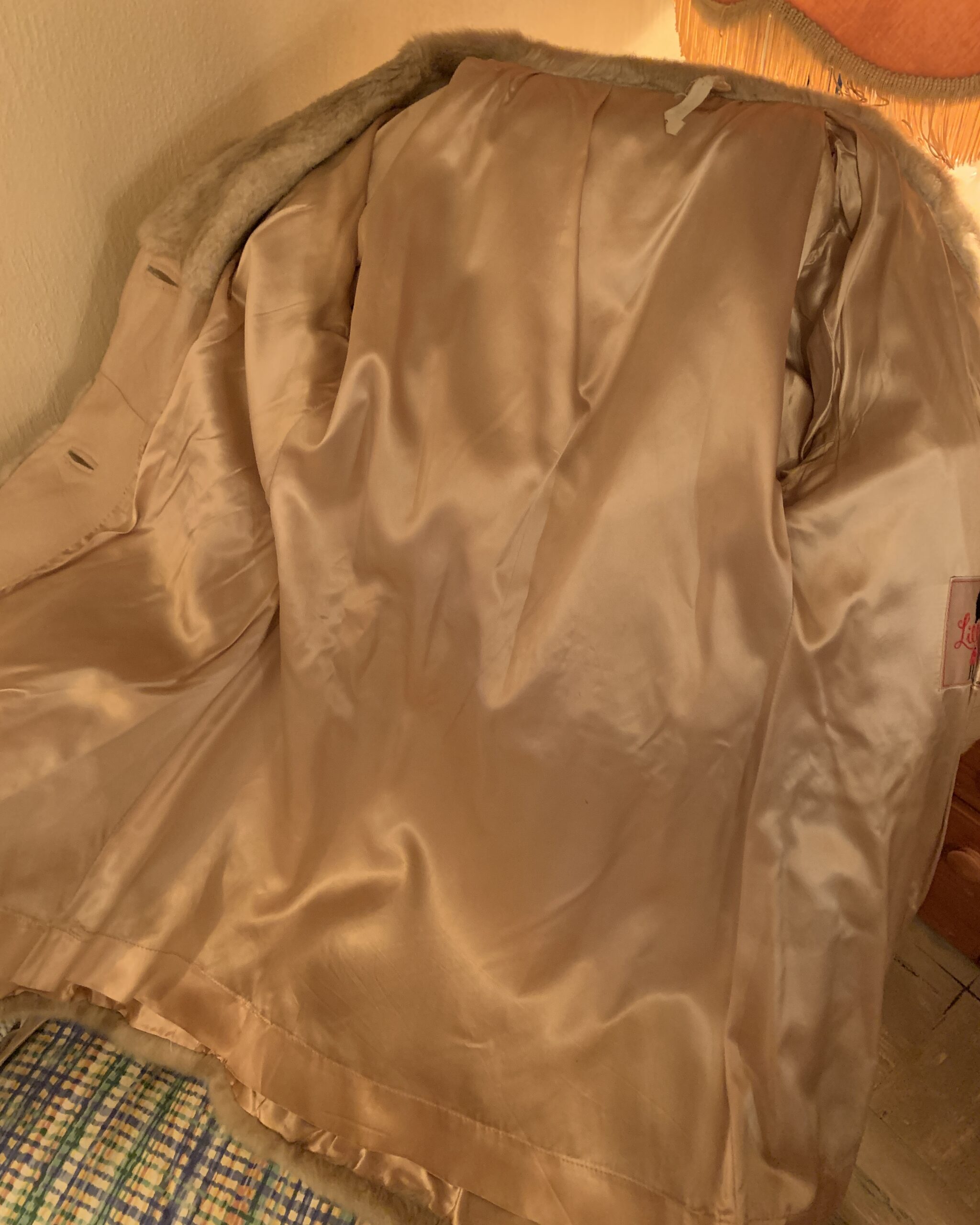 Champagne satin lining inside a vintage Lilli Ann London leather coat made in England.