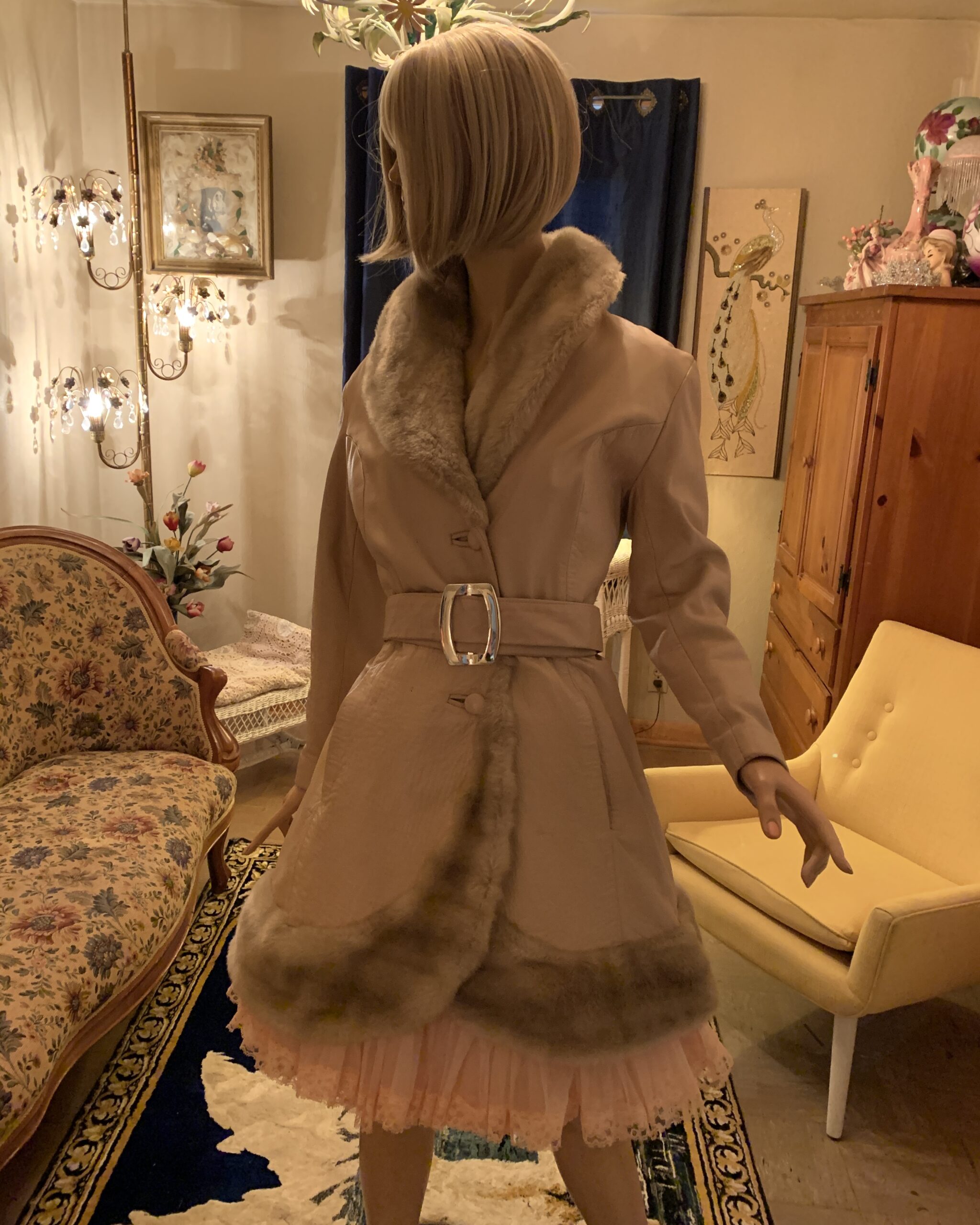 Lilli Ann London champagne leather coat with faux fur shawl collar, fur-trimmed hem, and wide belt displayed on mannequin.