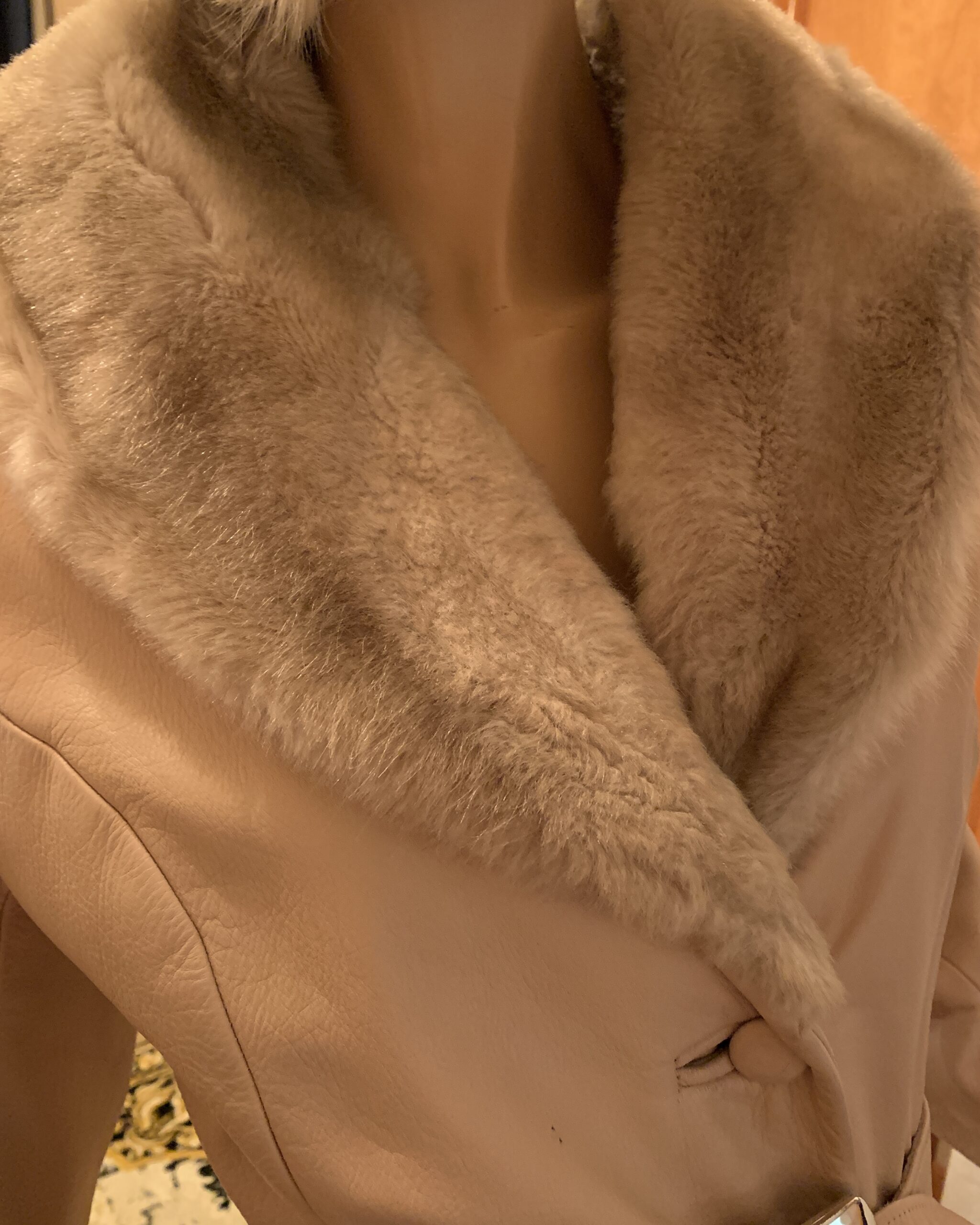 Close-up of the plush faux fur shawl collar on a vintage Lilli Ann London champagne leather coat.