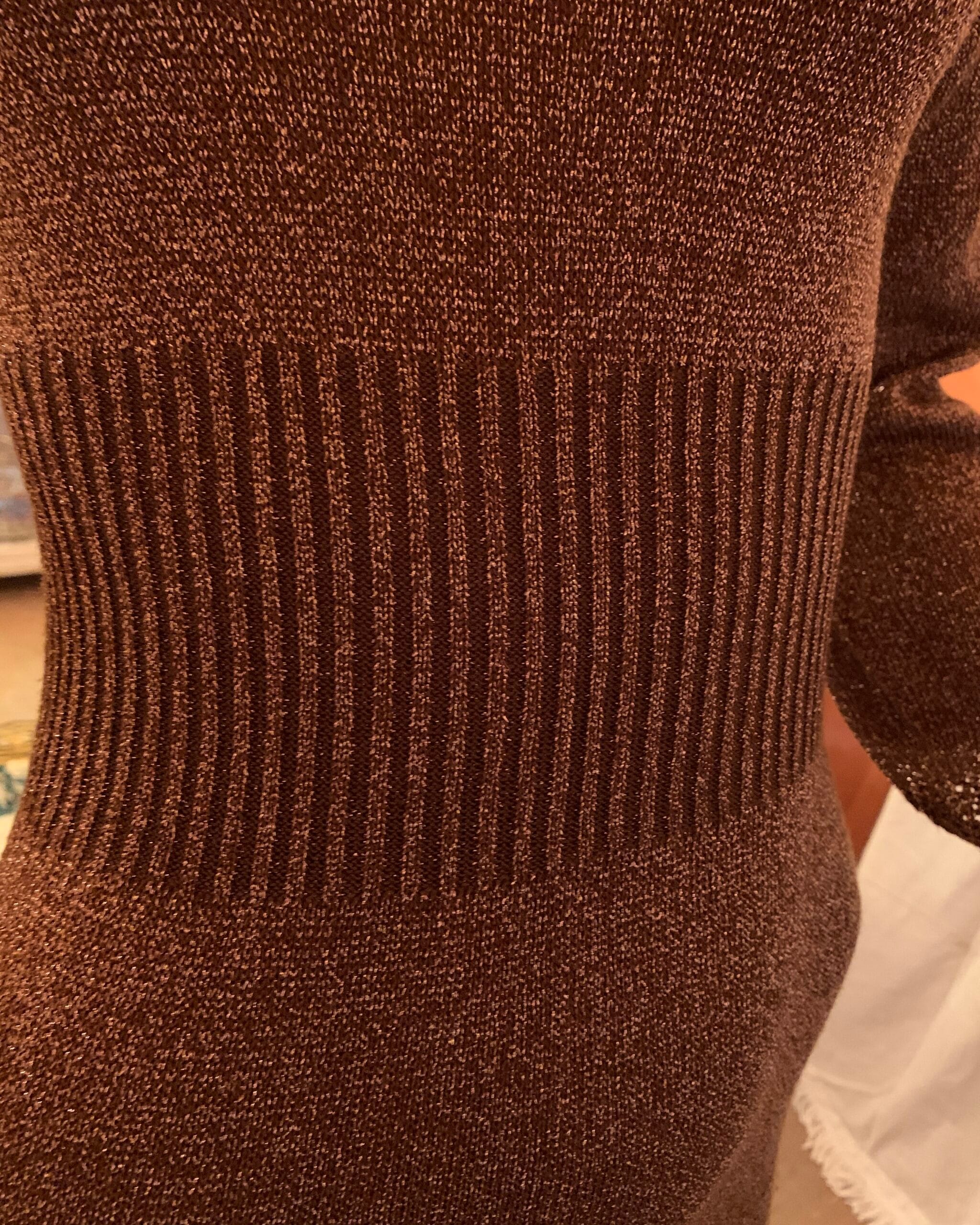Close-up of sculptural ribbed waist on Wenjilli bronze metallic knit dress