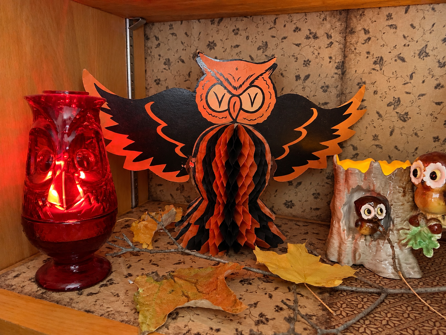 Vintage 1940s H. E. Luhrs honeycomb owl centerpiece displayed in the Halloween Cabinet beside red glass and ceramic owls.