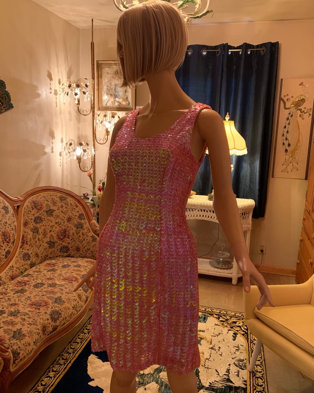 Side view of 1960s pink iridescent sequin cocktail dress on mannequin