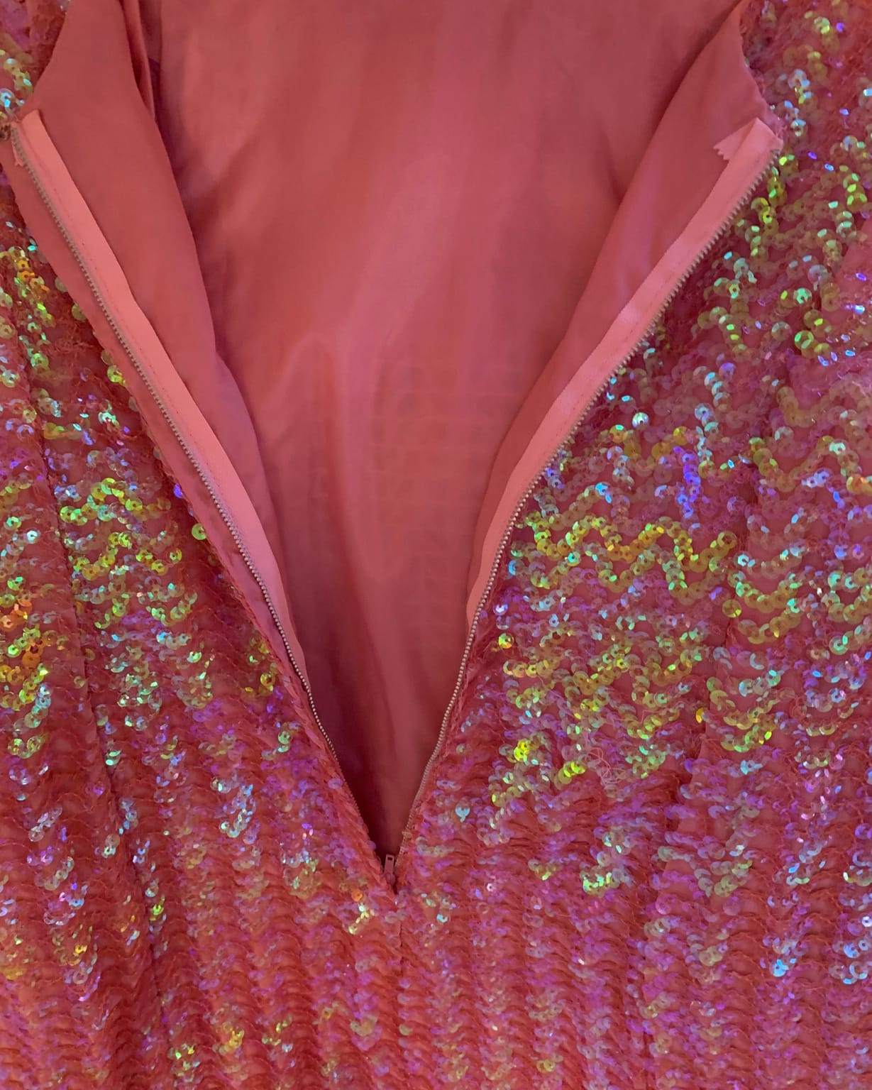Interior pink lining and back zipper of 1960s sequin cocktail dress