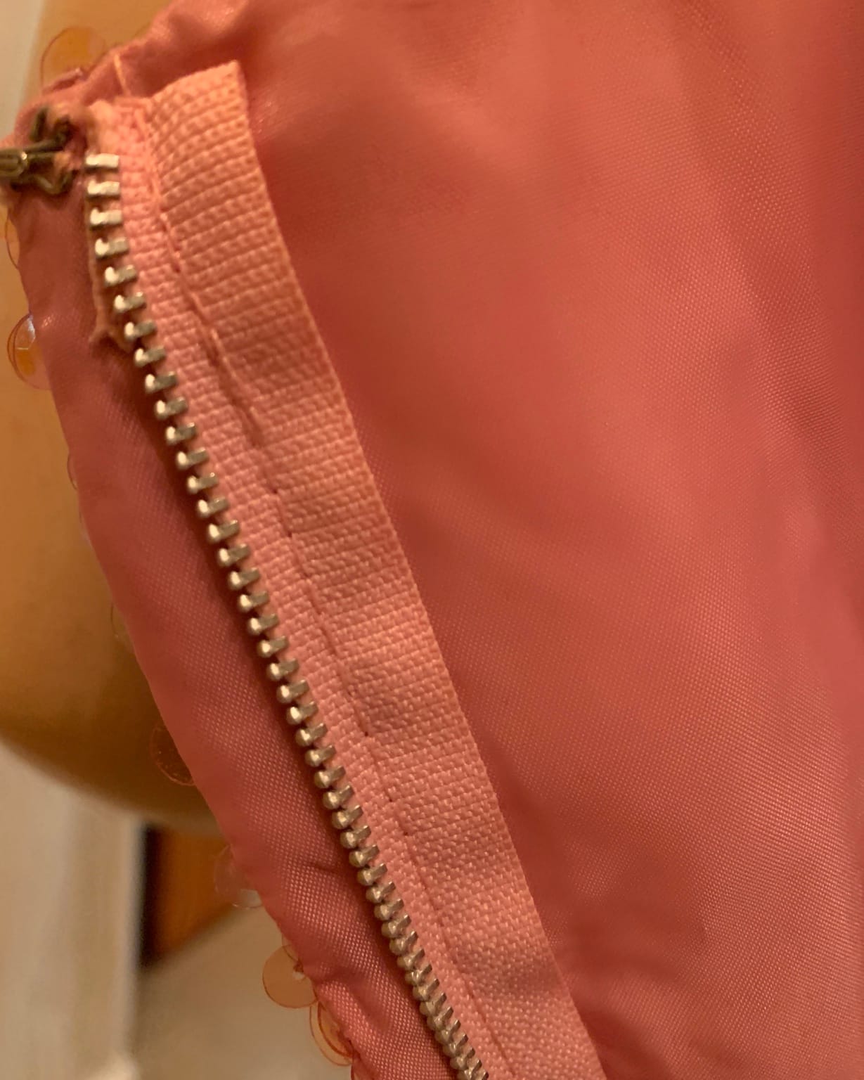 Close-up of original metal zipper on 1960s pink sequin cocktail dress