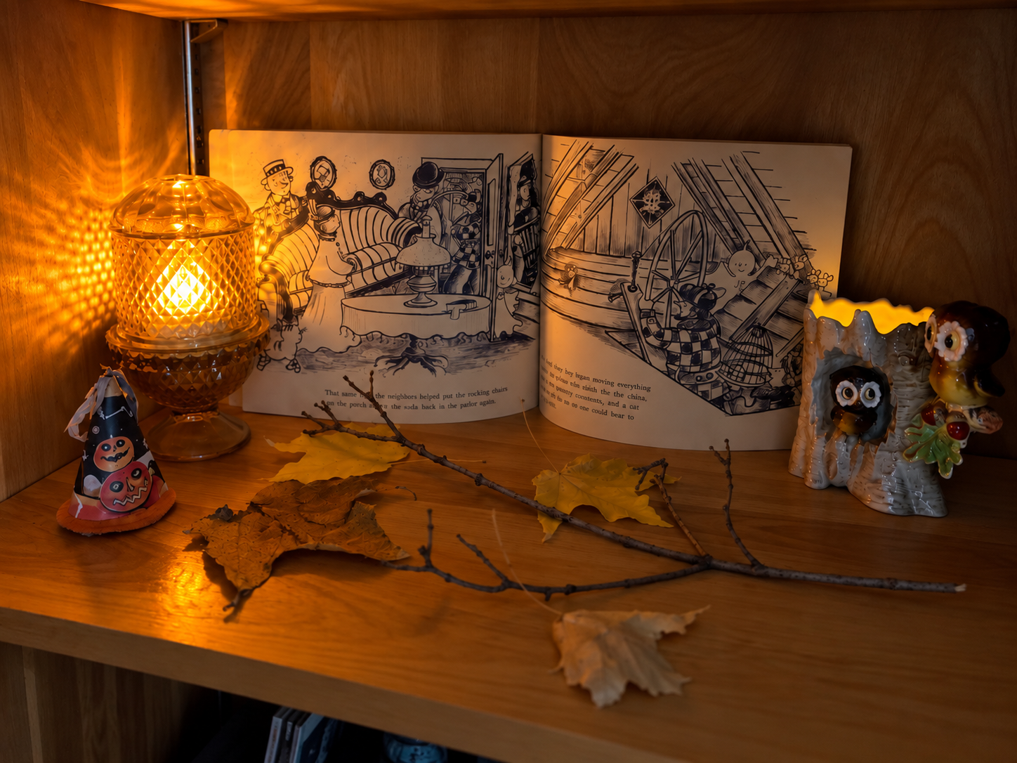 Open vintage Georgie the Ghost children’s book showing black-and-white interior illustrations in a cozy Halloween shelf display.