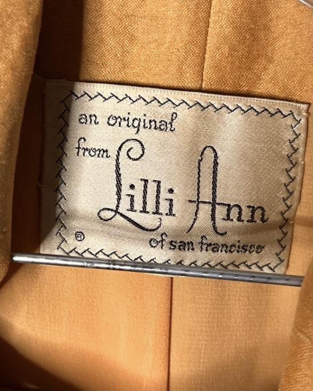 Cream fabric label reading “an original from Lilli Ann of San Francisco.”