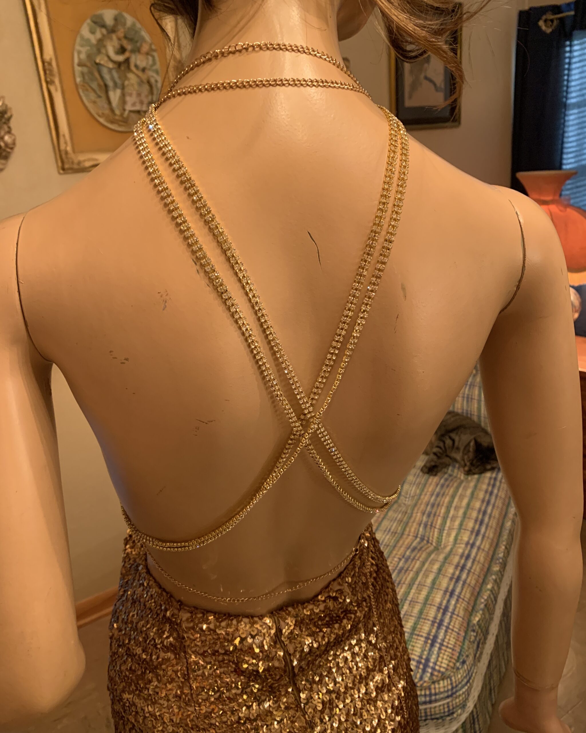 Close-up of double rhinestone straps crossing over the mannequin’s bare back.