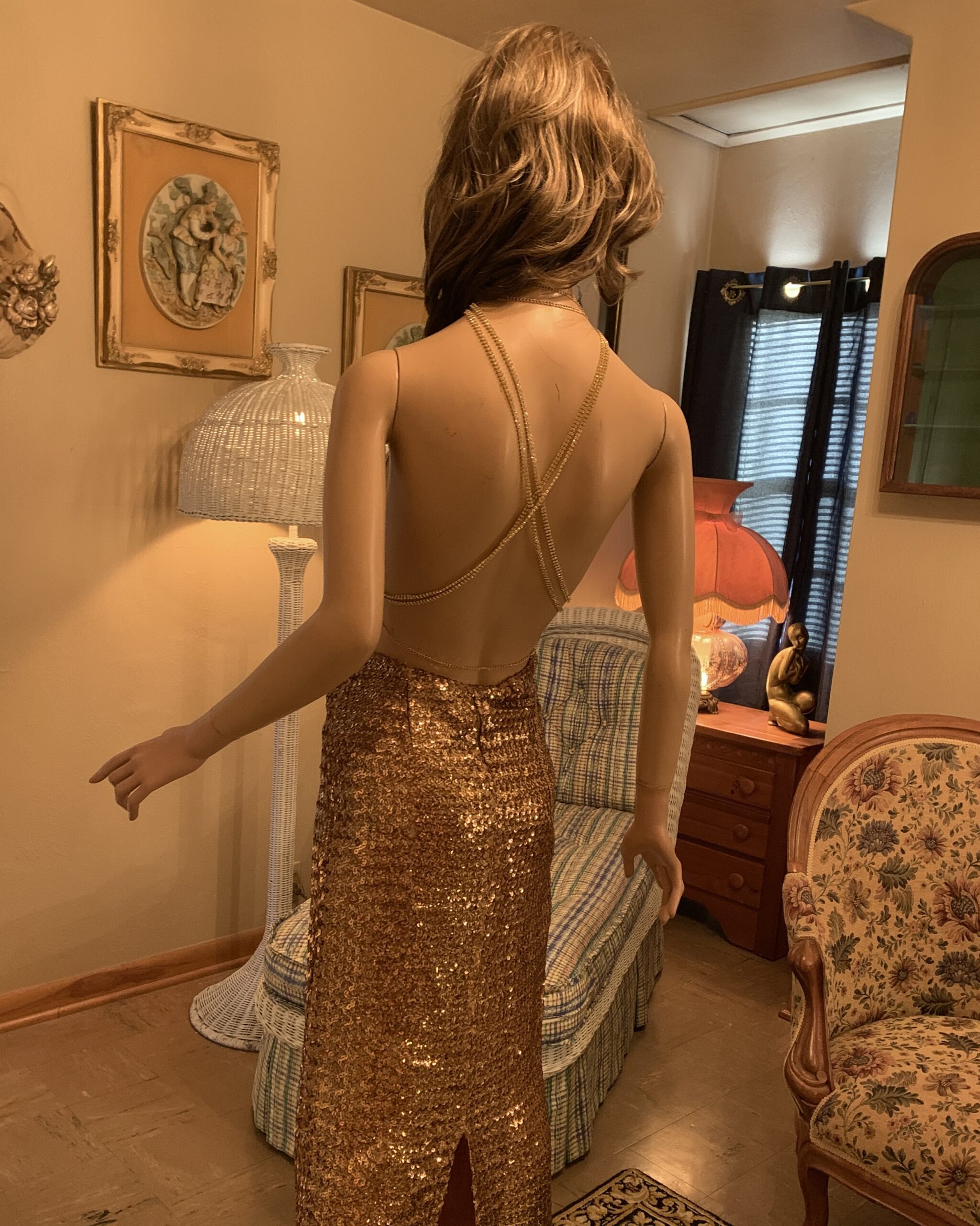 Rear view of the gold metal mesh top showing its open back and crossed rhinestone straps.